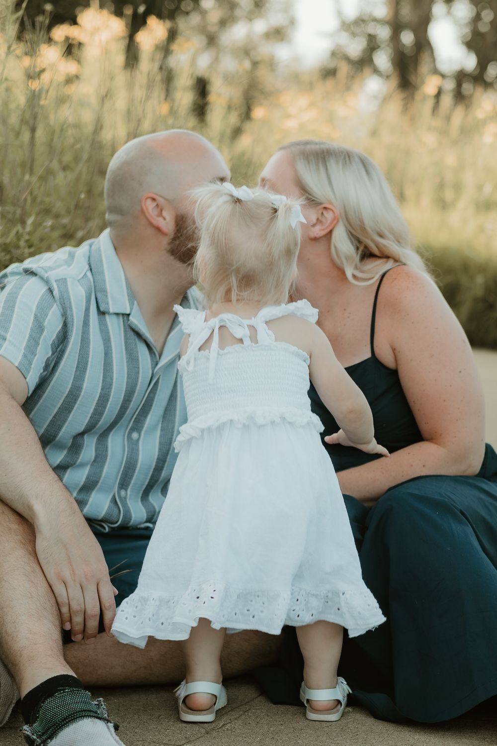 daughter kissing mom and dad