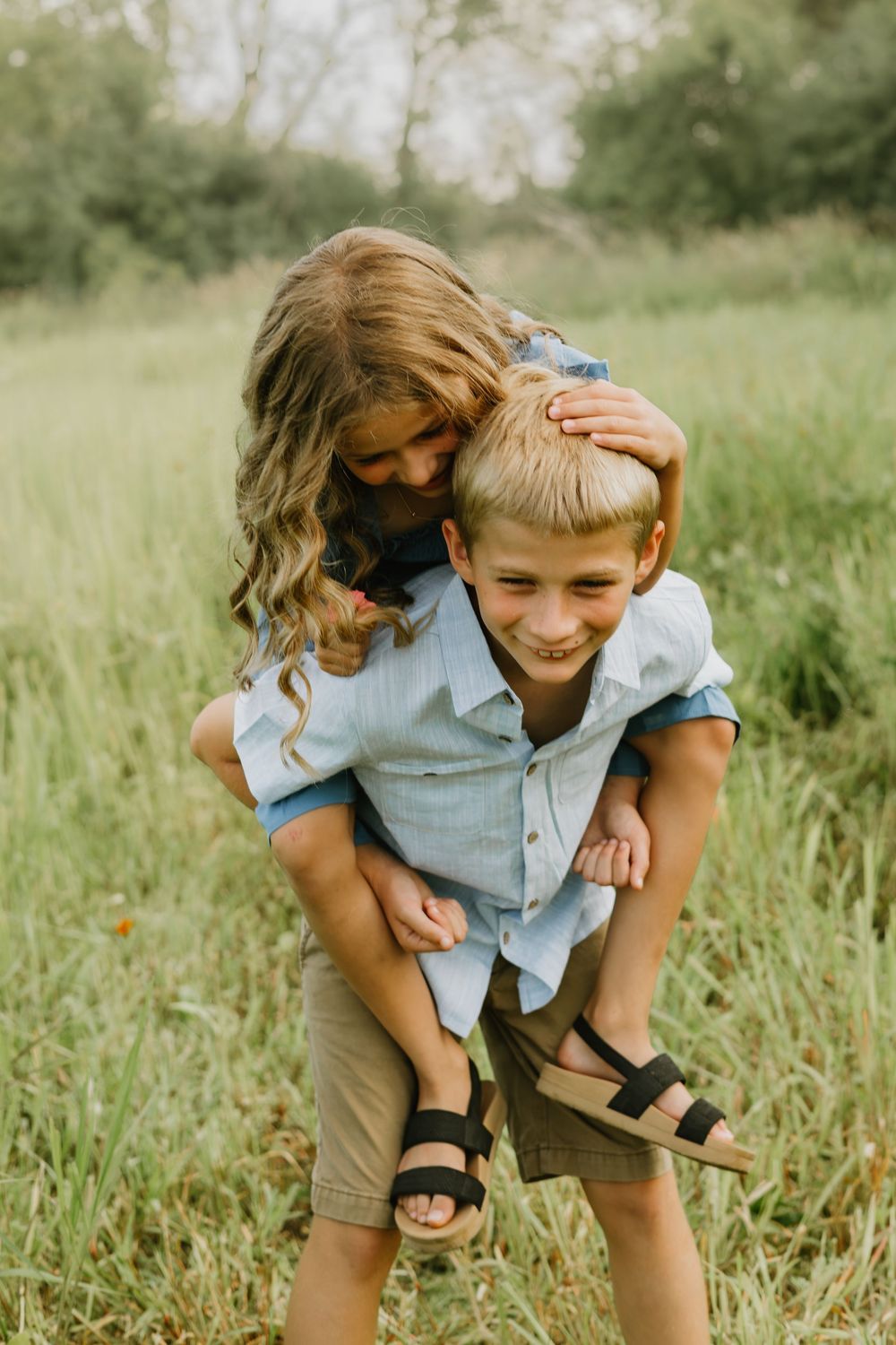 brother and sister in wildflower field