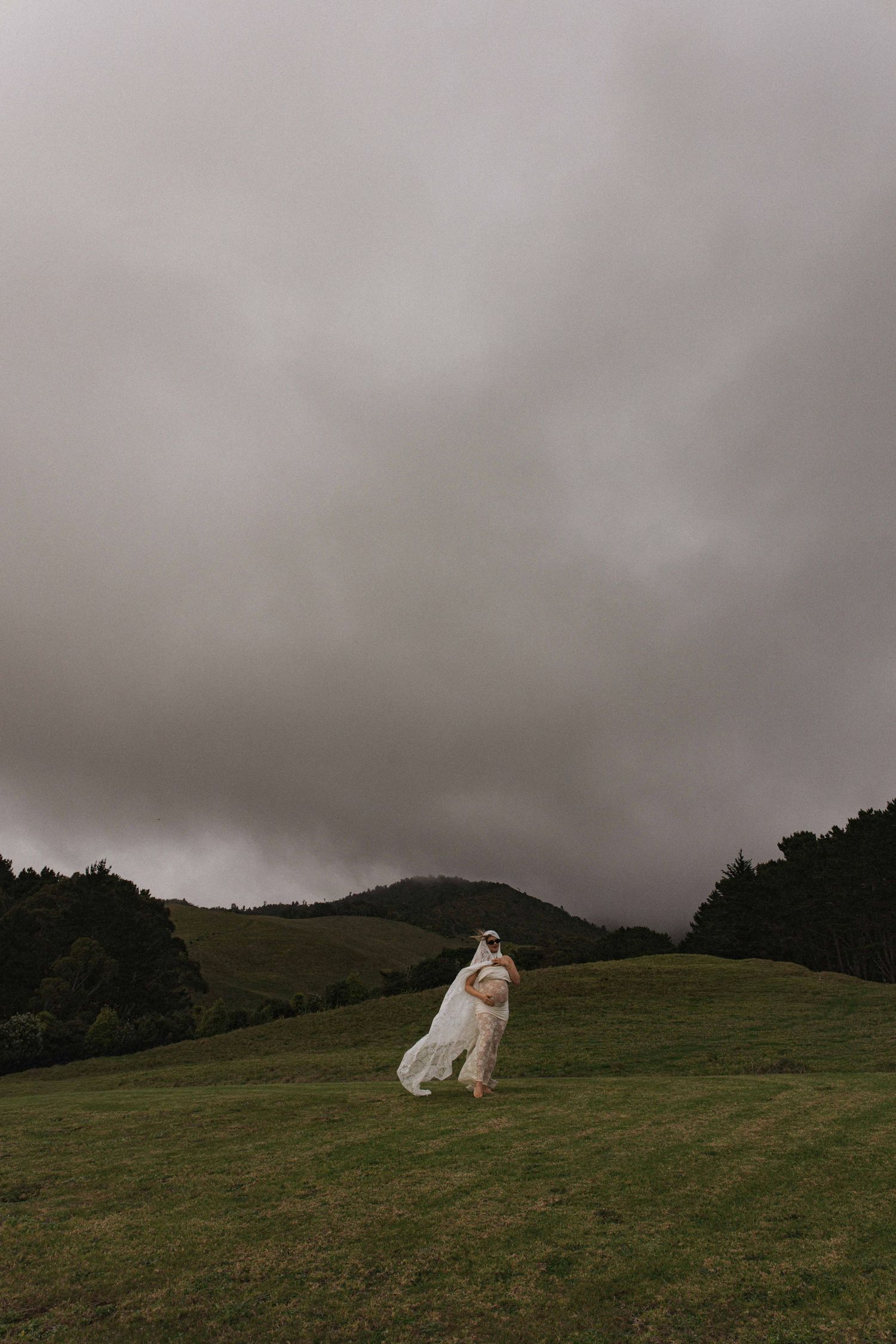 Pregnant woman during outdoor maternity photoshoot in Raglan, New Zealand