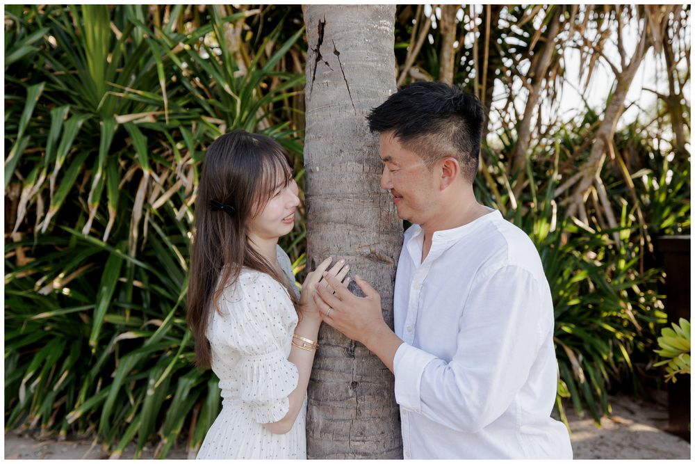 Sunset Family Photo Session at The St. Regis Punta Mita, sharing an intimate moment beneath the palm trees.