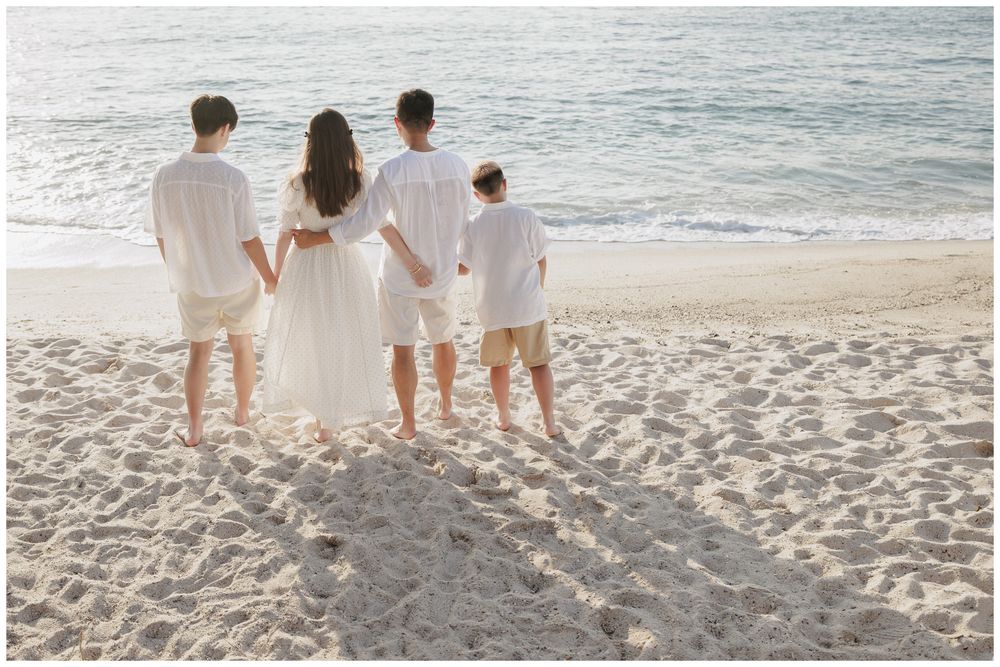 Punta Mita Family Photographer documenting a family enjoying the ocean waves together on the sandy beach.