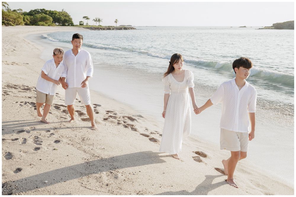 Punta Mita Family Photographer documenting a family enjoying the ocean waves together on the sandy beach.