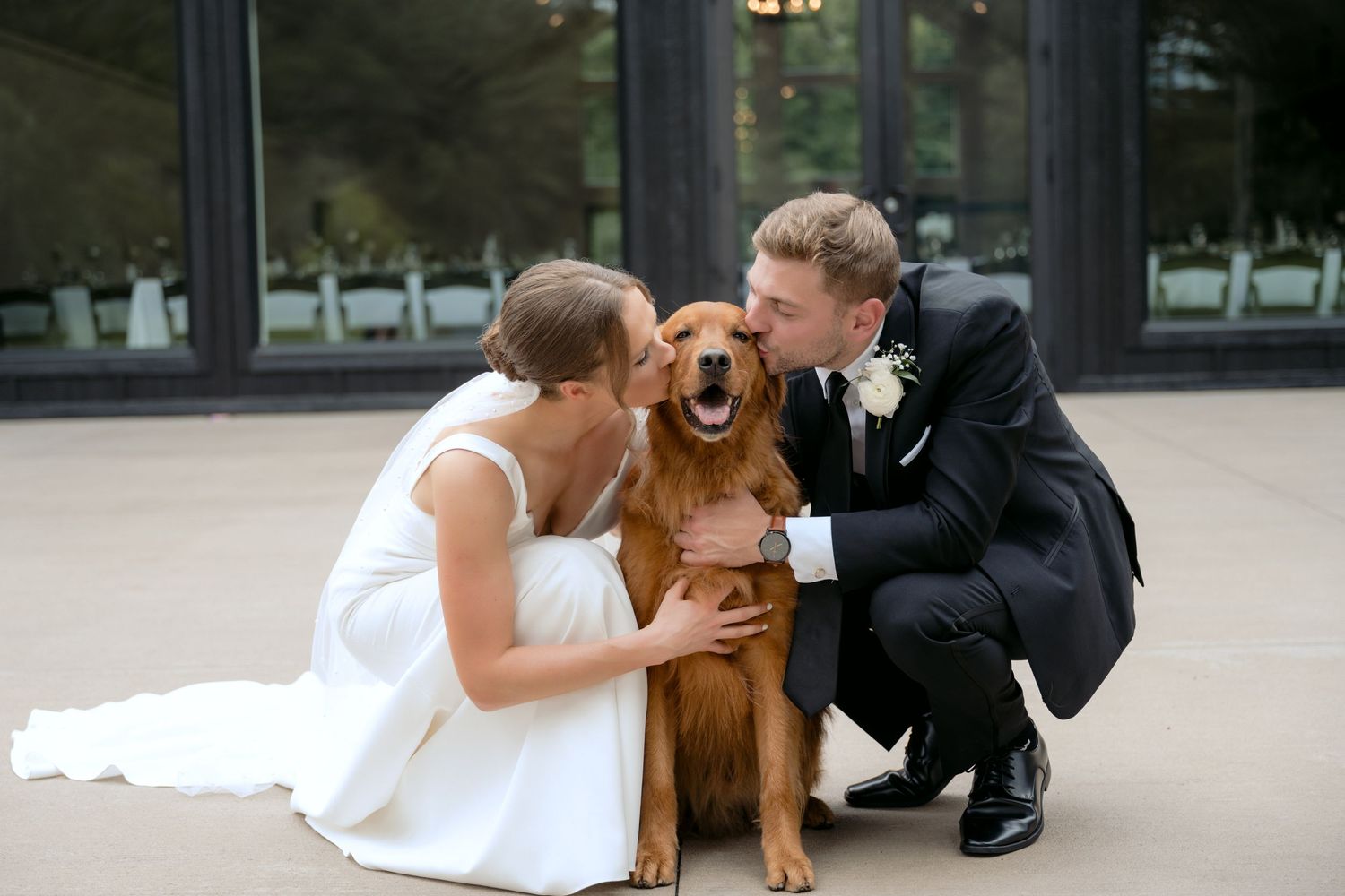 Bride & Groom kiss their golden retriever during portraits with their dog at La Pointe Events in Somerset, WI.