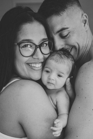 Intimate black and white family portrait showing affectionate moment together.