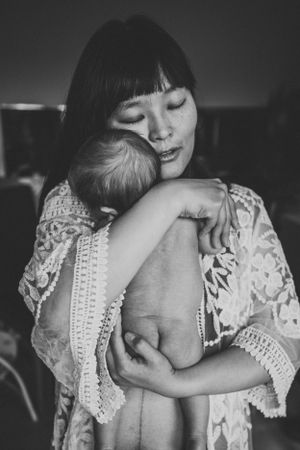 An intimate black and white portrait showing a tender embrace while wearing delicate lace.