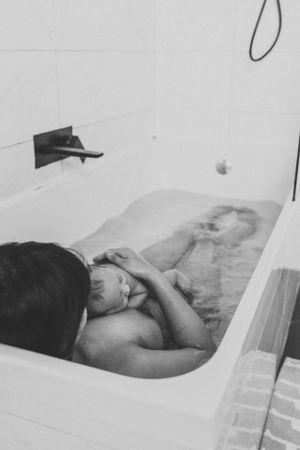 Artistic black and white photograph of a peaceful bathing scene in a white tub.