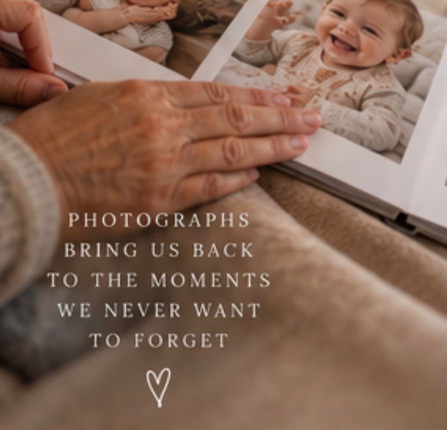Hands holding a photo album open to a smiling baby picture with quote about photographs preserving cherished memories.