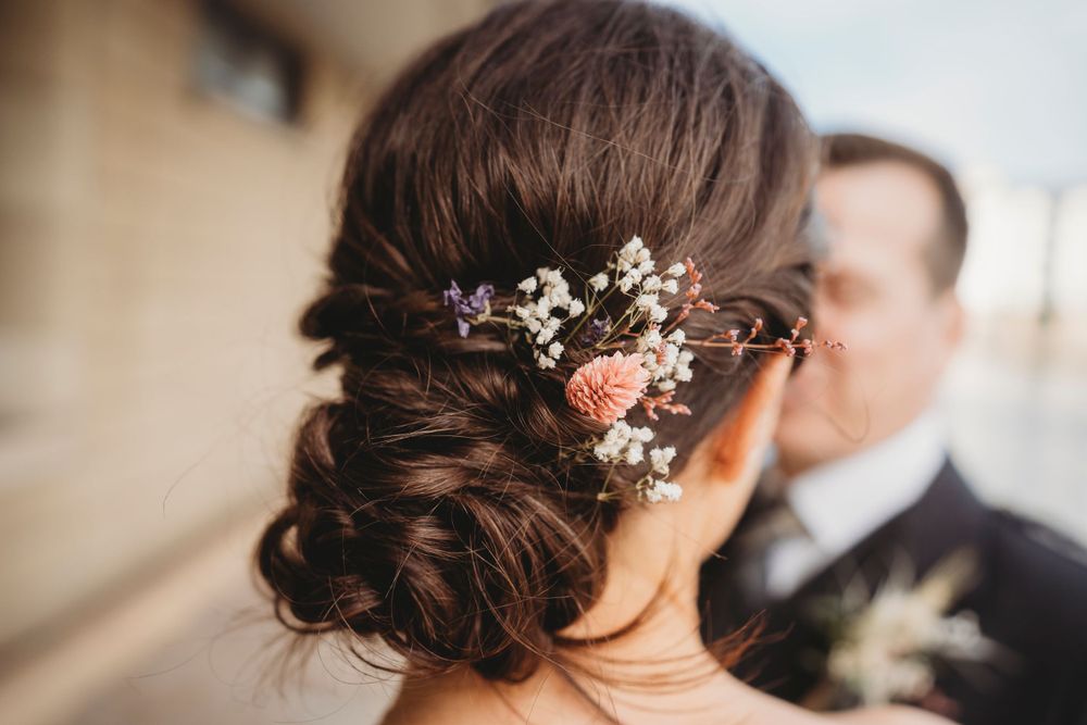 Elegant bridal hairstyle adorned with delicate flowers and baby's breath.