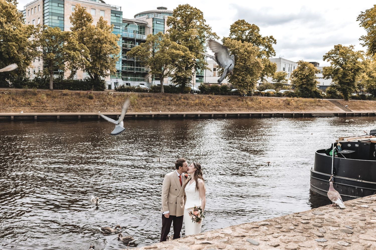 Relaxed couple kissing during an engagement shoot