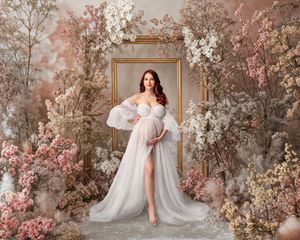 Elegant woman in an ivory couture pearl-encrusted dress, posed against a floral arch digital backdrop.