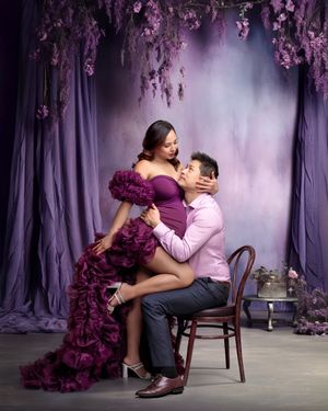Sydney luxury maternity: parents-to-be embracing lovingly, captured beautifully in the studio by Caz Captures