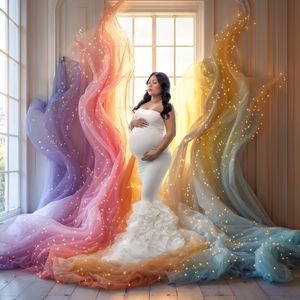 A rainbow themed maternity photoshoot of a woman glowing in white against rainbow swirls and window backlight.