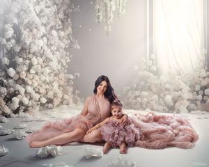 Sydney luxury motherhood: mother and daughter in matching pink flowing dresses, artfully captured.