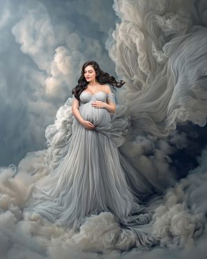 Pregnant mother stands amongst blue gray clouds her dress floats up adding to the ethereal look of the maternity portrait.
