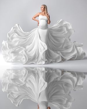 Sydney luxury maternity: expectant mum in an ivory white flowing dress, artfully captured.