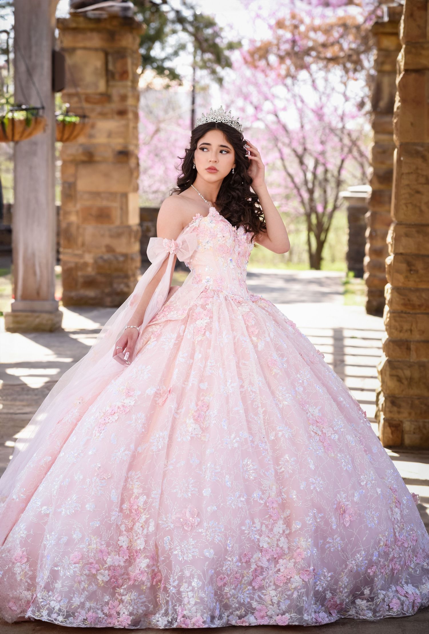 Fort Worth quince photographer Fotolilly Photography capturing a pink ball gown with floral lace in a stone colonnade.