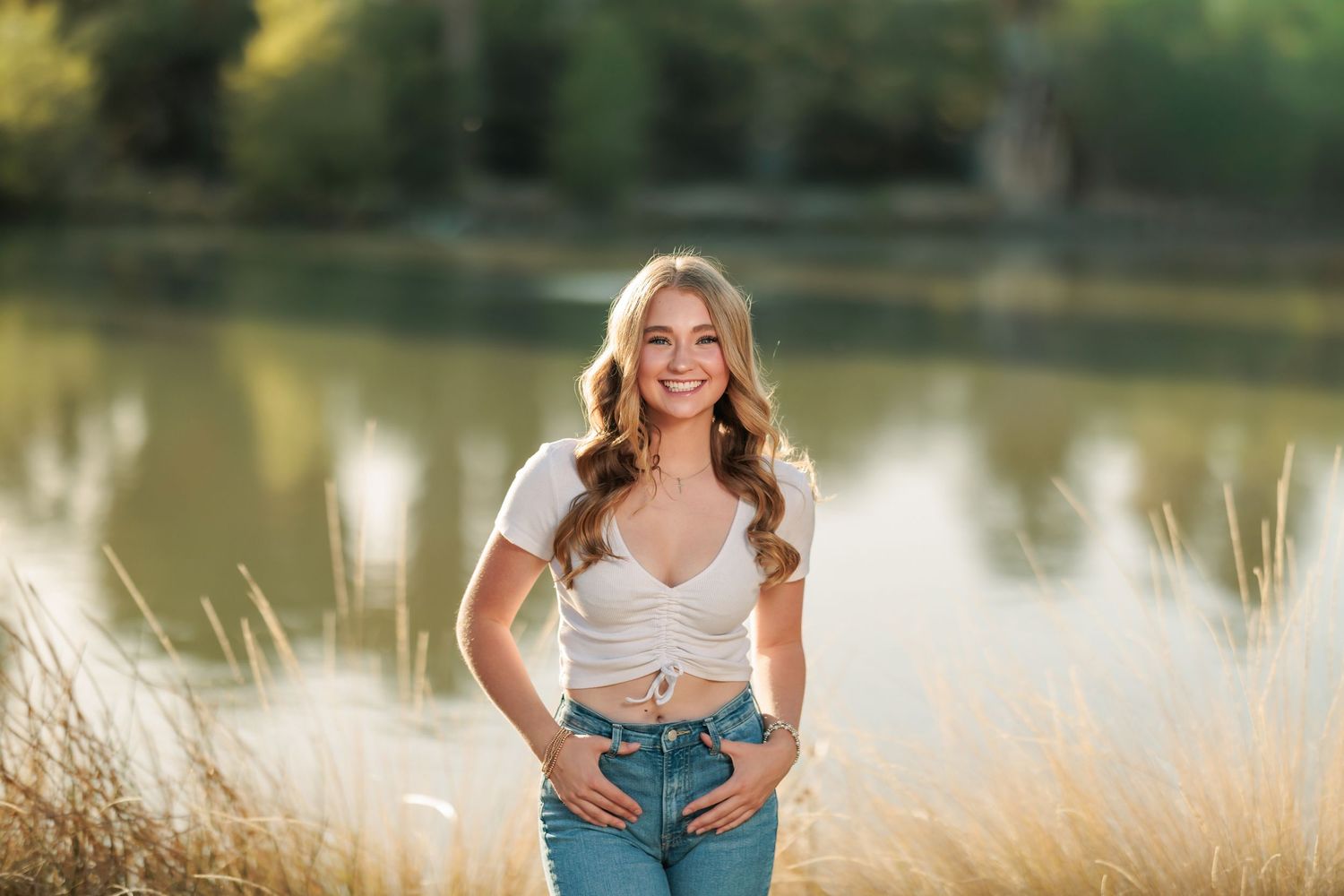 Senior girl posing at agua caliente in Tucson, AZ near water