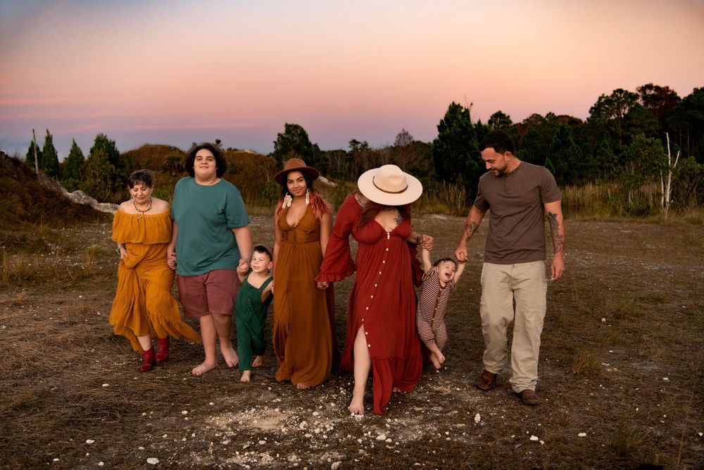 Multi-generational family walking together at golden hour in Tampa, FL, capturing authentic connection and joy.