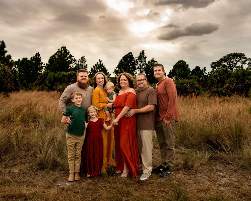Family members sharing a meaningful moment in a scenic Clearwater, FL nature preserve beneath dramatic Florida skies.