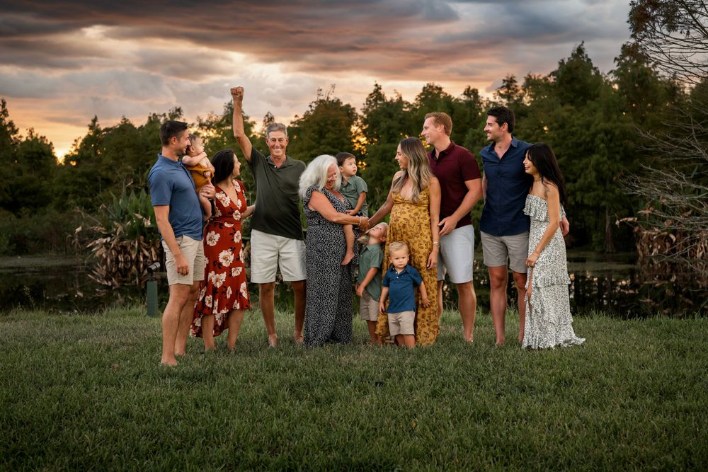 Extended family portrait at sunset in Tampa, Florida, featuring grandparents, parents, and grandchildren outdoors.