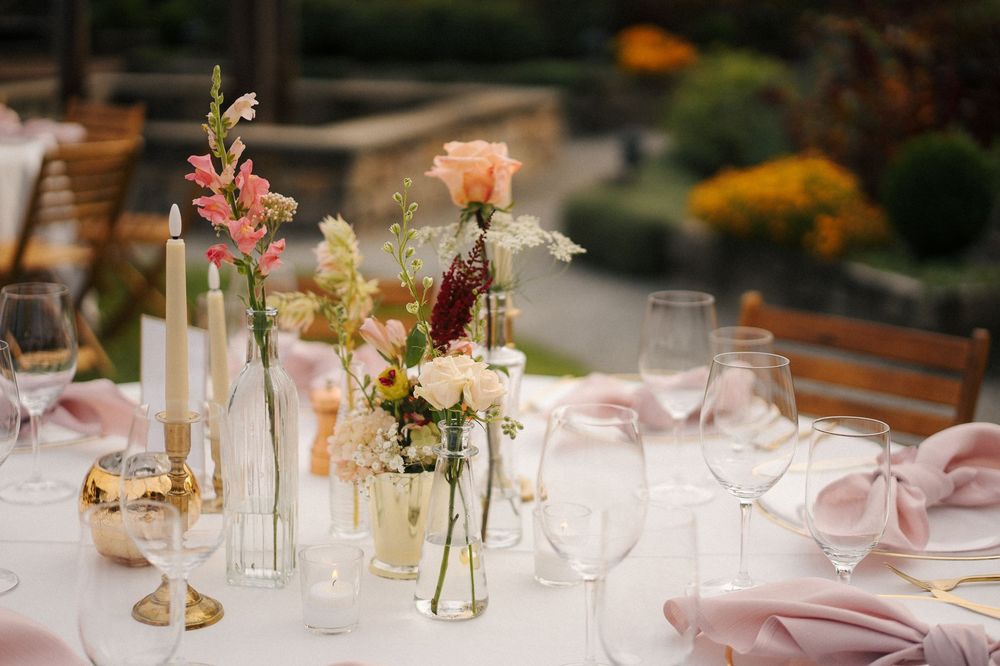 Outdoor wedding reception tables with florals at Willows Lodge in Woodinville.