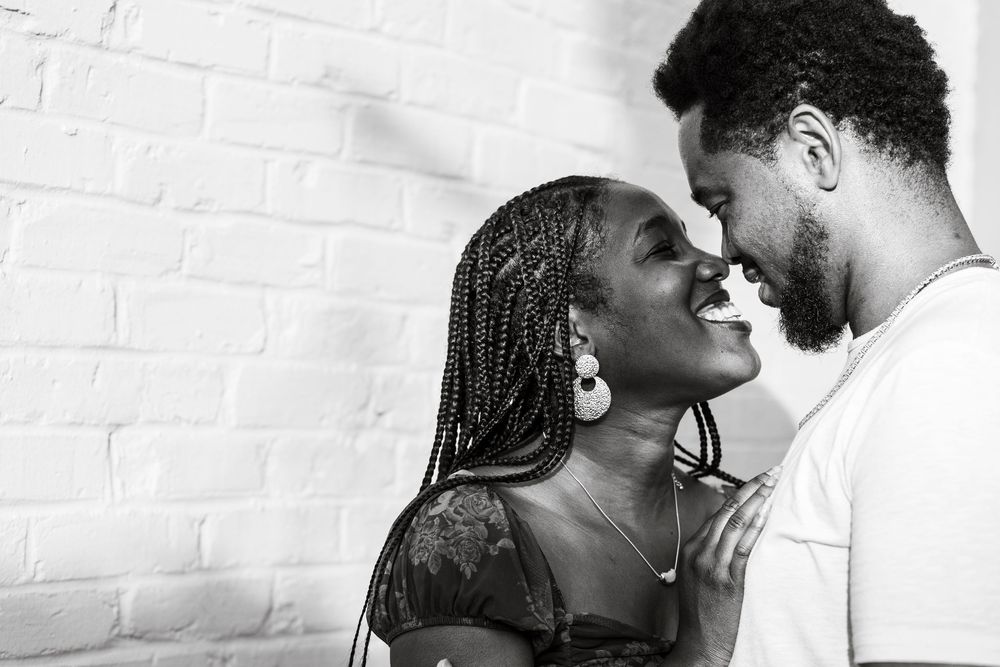Black and white photo of a joyful couple sharing an intimate moment, smiling face to face in Lexington, Kentucky.