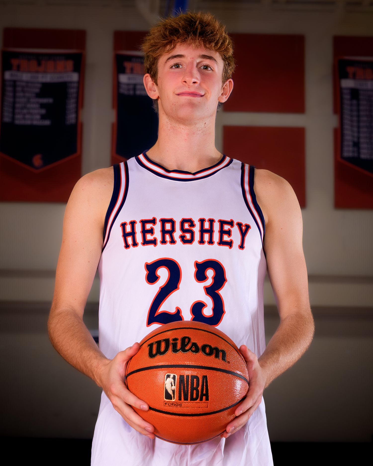 Hershey boys basketball player #23 holding a ball, media day portrait, by Deanna Fox, SportsFox Photography based in Hershey PA