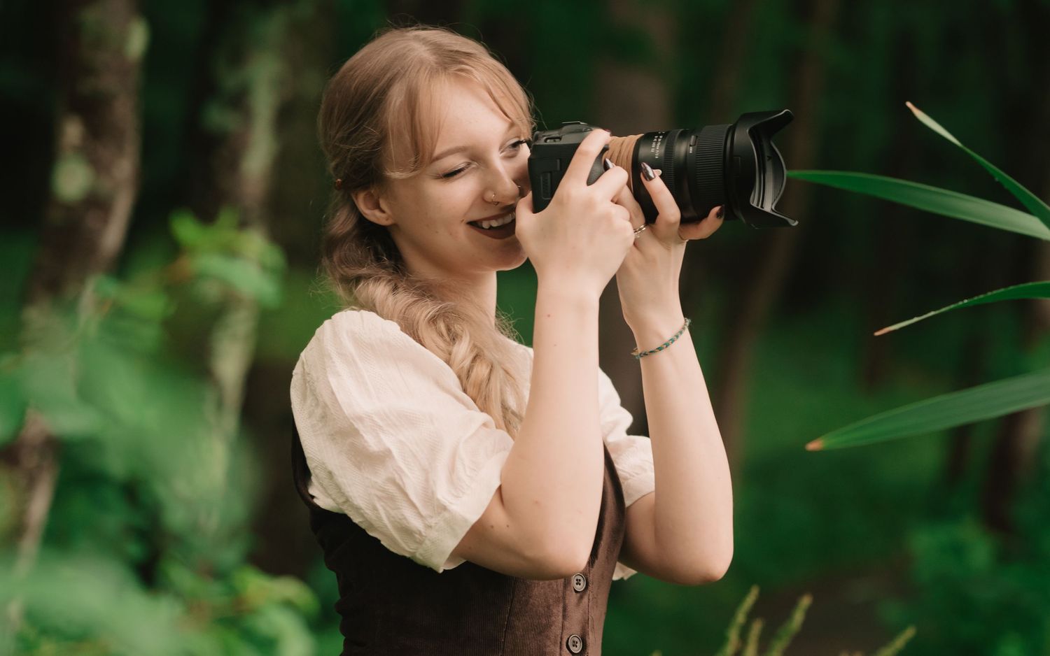 Emma Cayea, photographer and owner of Emma Cayea Photography, posing outdoors for a personal portrait during golden hour