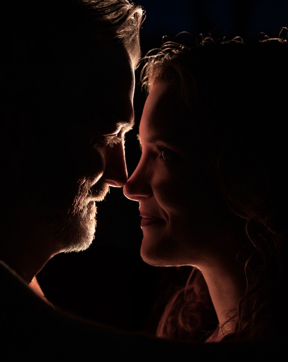 Intimate low-light portrait of a couple nose to nose during a couples session in Mountain Home, Arkansas