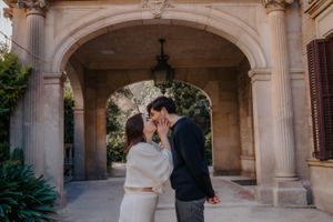 Candid couple sharing a fun, playful moment outside the elegant villa inside Jardin Julio Munoz Barcelona
