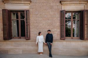 Tender couple embrace beside classical sculptures in the quiet, crowd-free Jardin Julio Munoz sanctuary