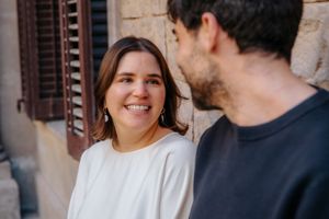 Laughing couple embraced under soft morning light filtering through trees at Jardin Julio Munoz Barcelona
