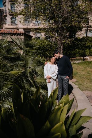 Bubbly couple laughing together near the peaceful stone ponds at the secret Jardin Julio Munoz estate