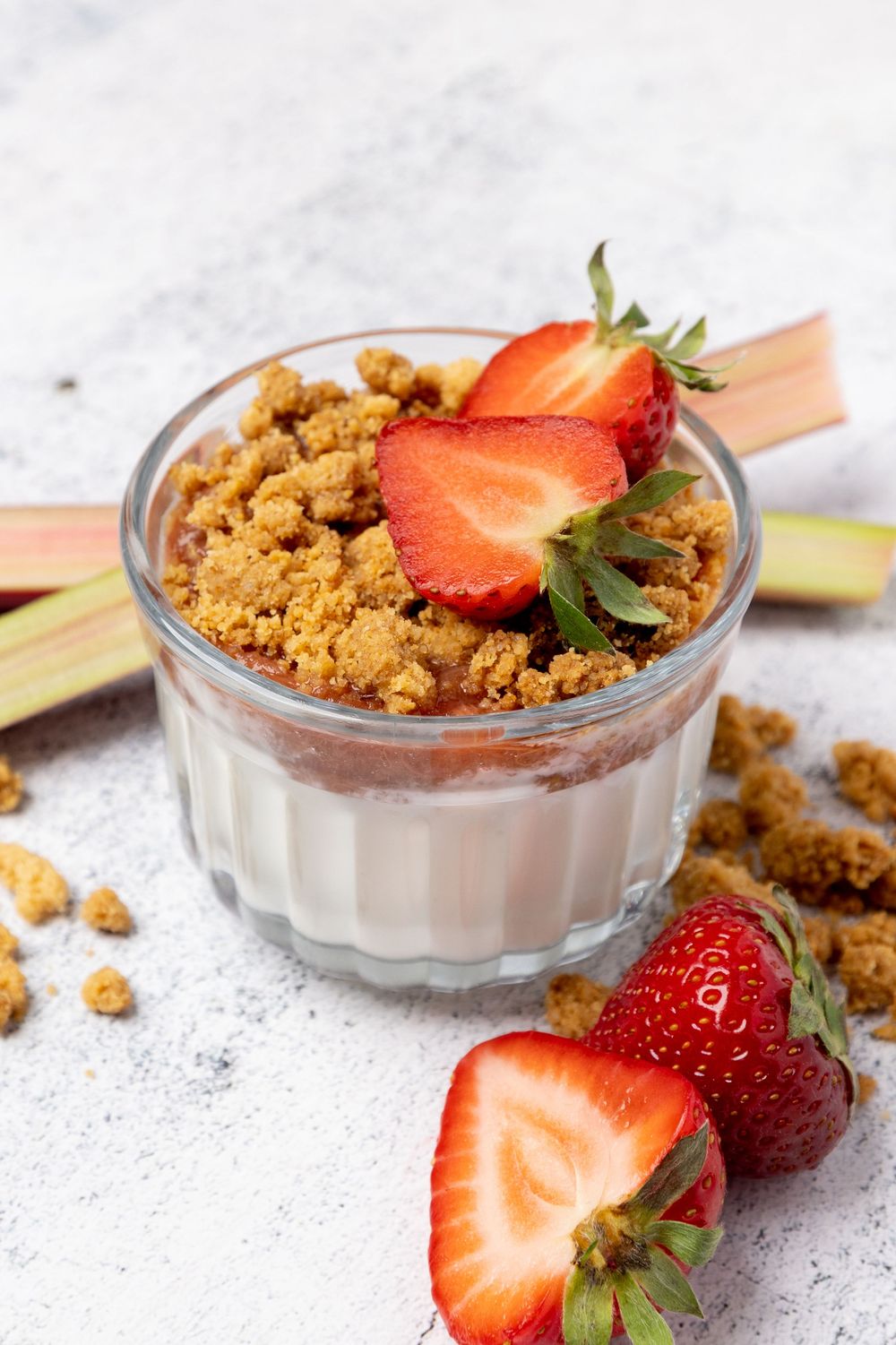 Creamy chocolate mousse dessert topped with fresh strawberries and crumbled cookie pieces in glass serving dishes.