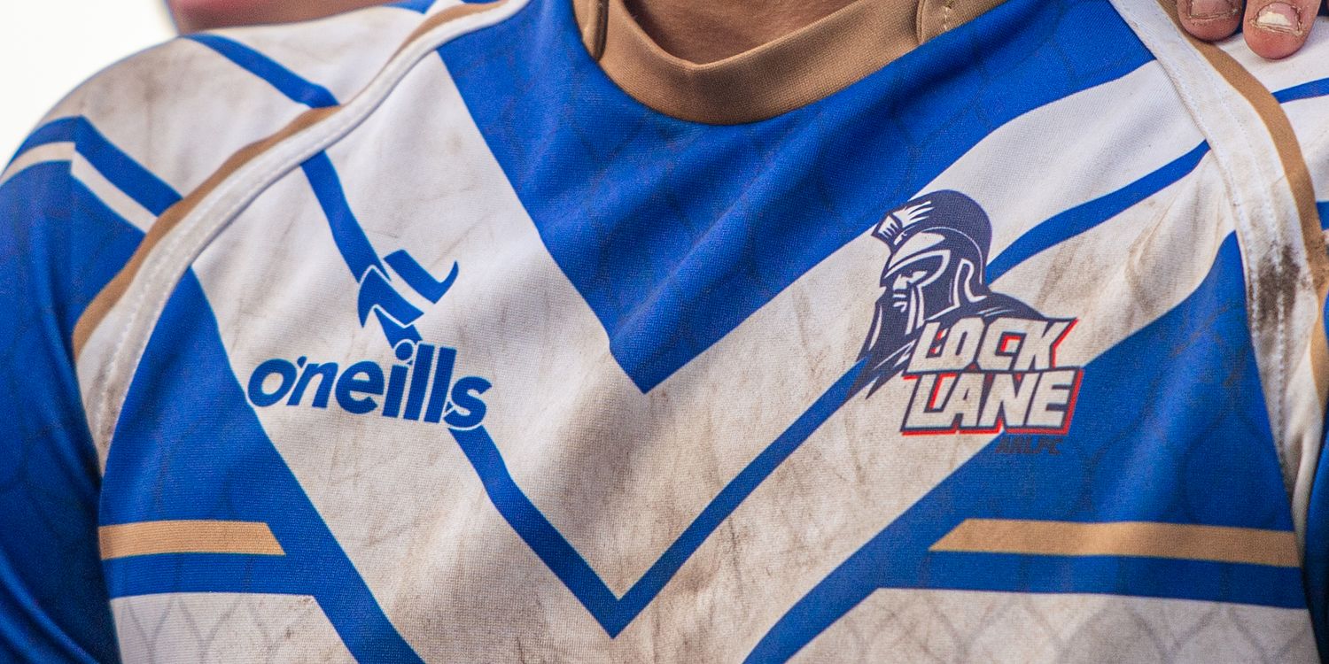 White and blue O'Neills rugby league jersey featuring Lock Lane club badge closeup shot.