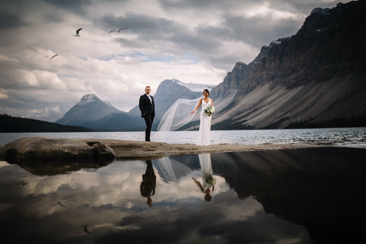 Lake Louise wedding couple reflected in Bow Lake