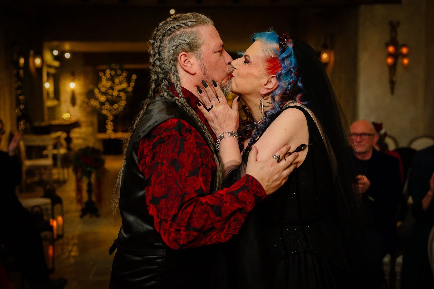 Bride and groom sharing their first kiss as husband and wife at a Halloween wedding at Le Petit Chateau