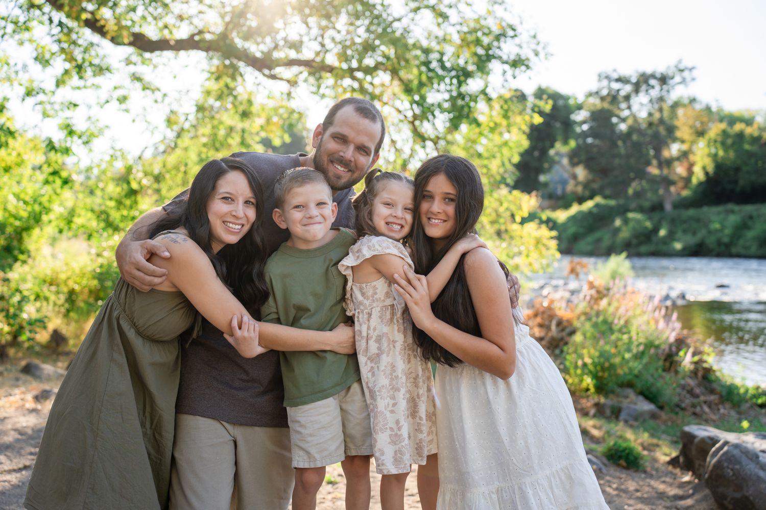 Family portrait everyone hugging by the Rogue River