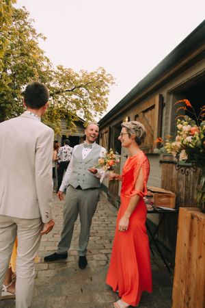 Bruidspaar lacht en praat tijdens de zomerse trouwreceptie met de gasten bij Annedge in Deinze