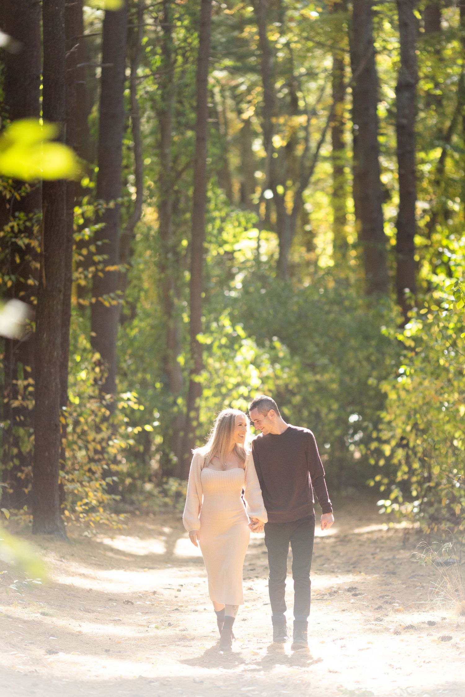 Couple walking hand in hand during a relaxed Long Island couple session at Prosser Pines, Middle Island.