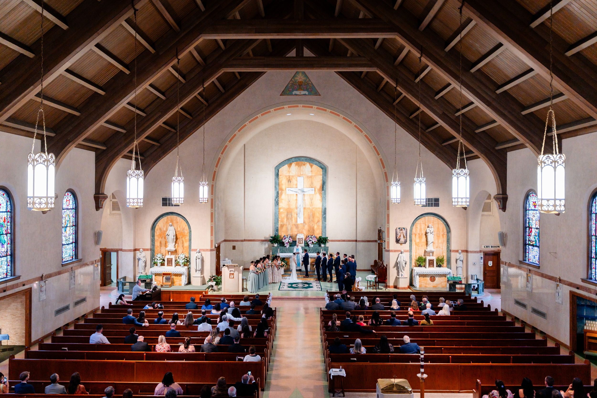 Elegant Catholic church interior filled with wedding guests during a beautiful ceremony.