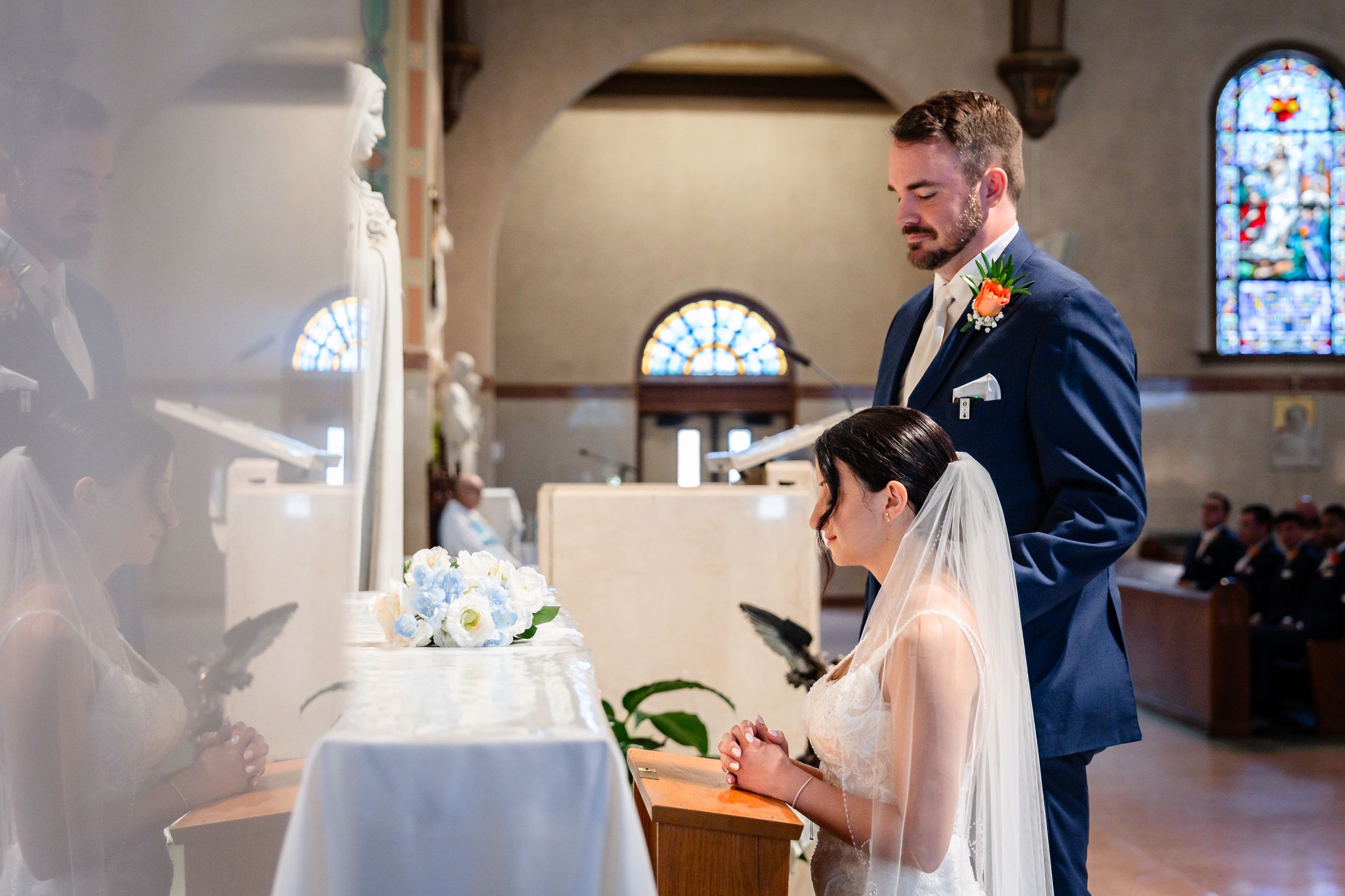 Bride and groom signing wedding documents at church altar during ceremony.