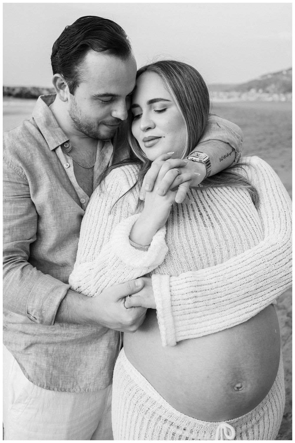 One & Only Mandarina family photographer showcasing a maternity photographer session with an intimate couple embrace surrounded by nature.