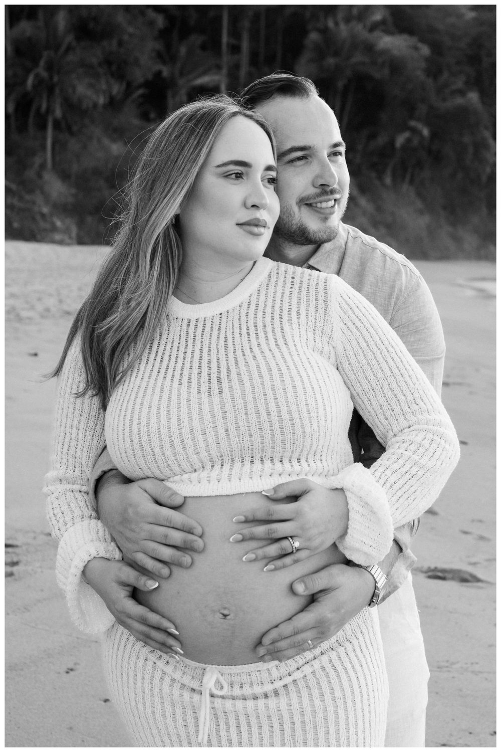 One & Only Mandarina family photographer documenting maternity photos with a couple celebrating their upcoming family by the beach.