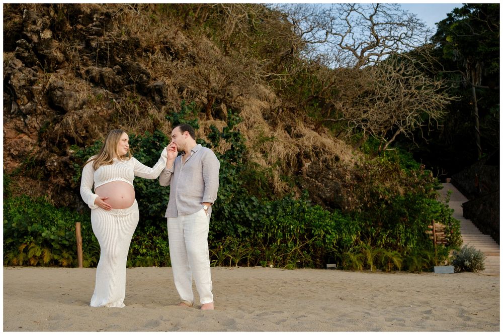 One & Only Mandarina family photographer showcasing couple photography on the beach with a maternity session surrounded by lush greenery.
