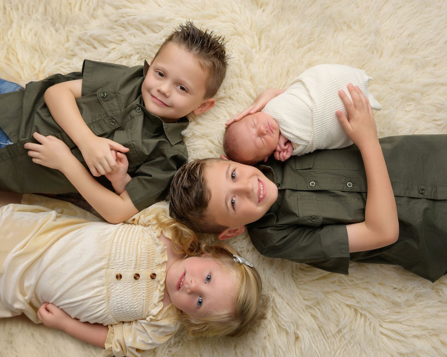 Siblings with their newborn baby at Arianna’s Zephyrhills newborn photography studio