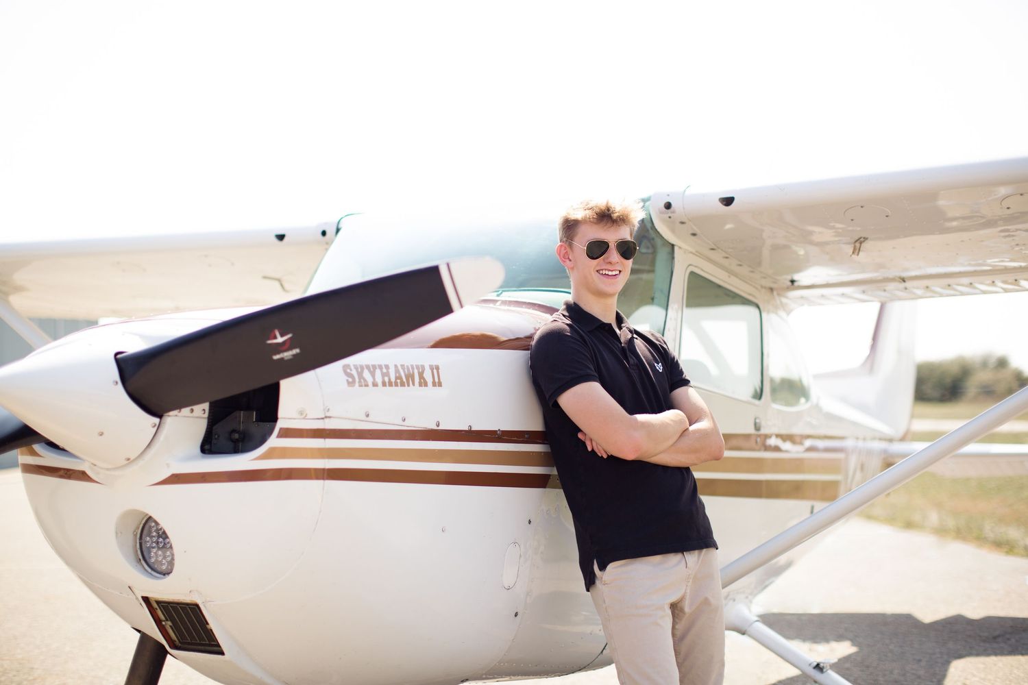 Senior boy outdoor portrait with airplane in Howell, Michigan by South Lyon, MI photographer