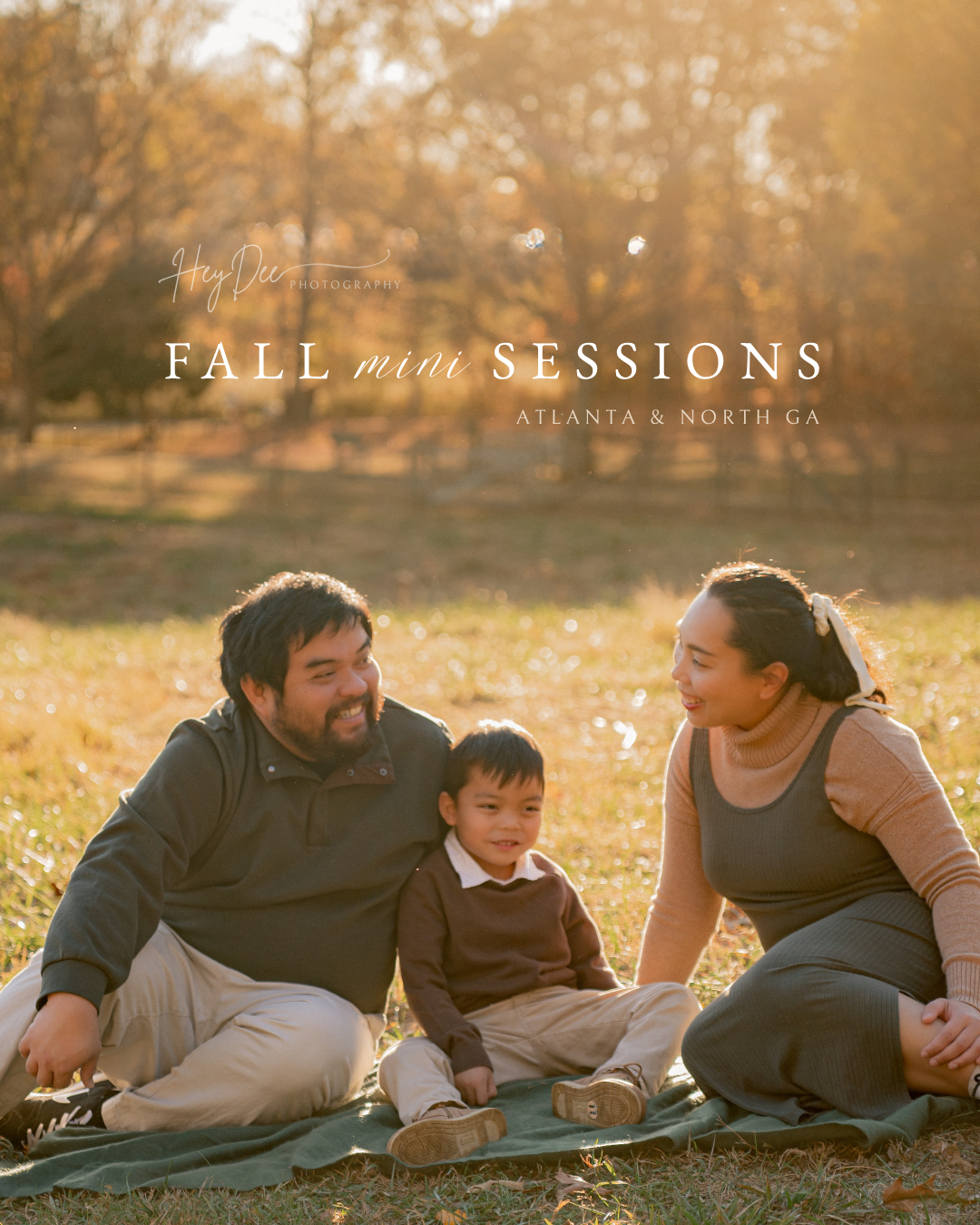 Family of three sitting on a blanket in a sunlit field during fall mini sessions in Atlanta and North GA.