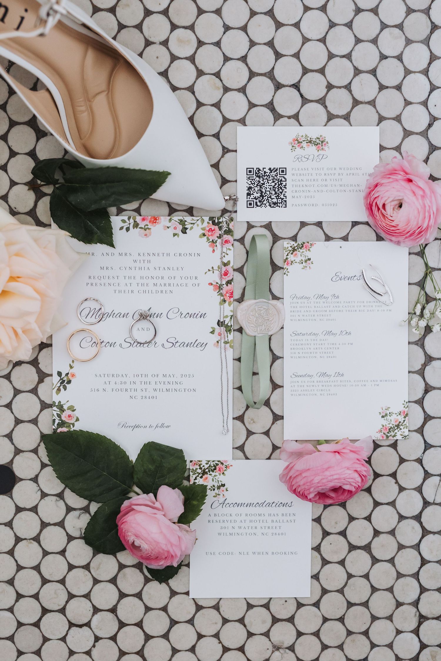 Elegant floral wedding invitation suite with pink ranunculus flowers on hexagon tile background.