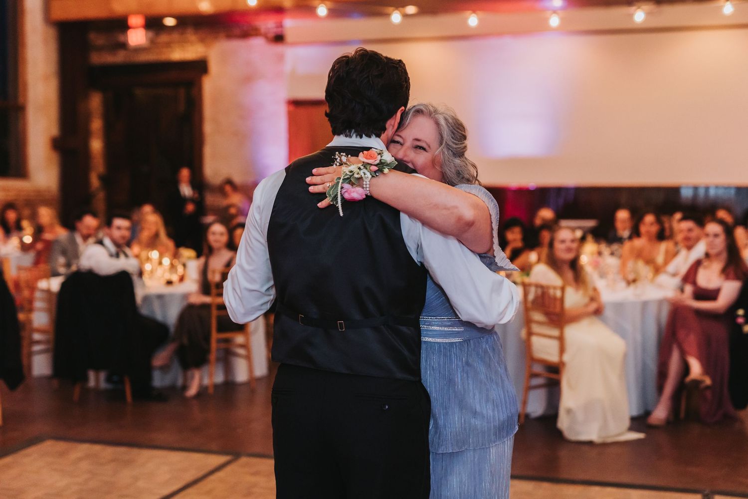 Groom shares a tender dance with his mother during the mother-son dance at the wedding reception.